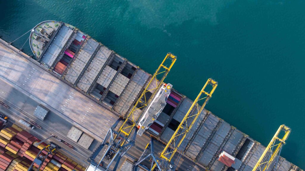 Aerial view Container cargo ship loading unloading container import export sea port, Global trade business container cargo ship freight shipping commercial trade logistic transportation international.