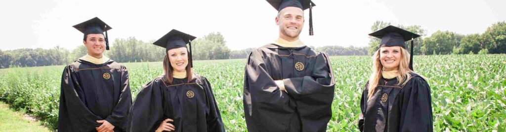 Cap and gown photo in field