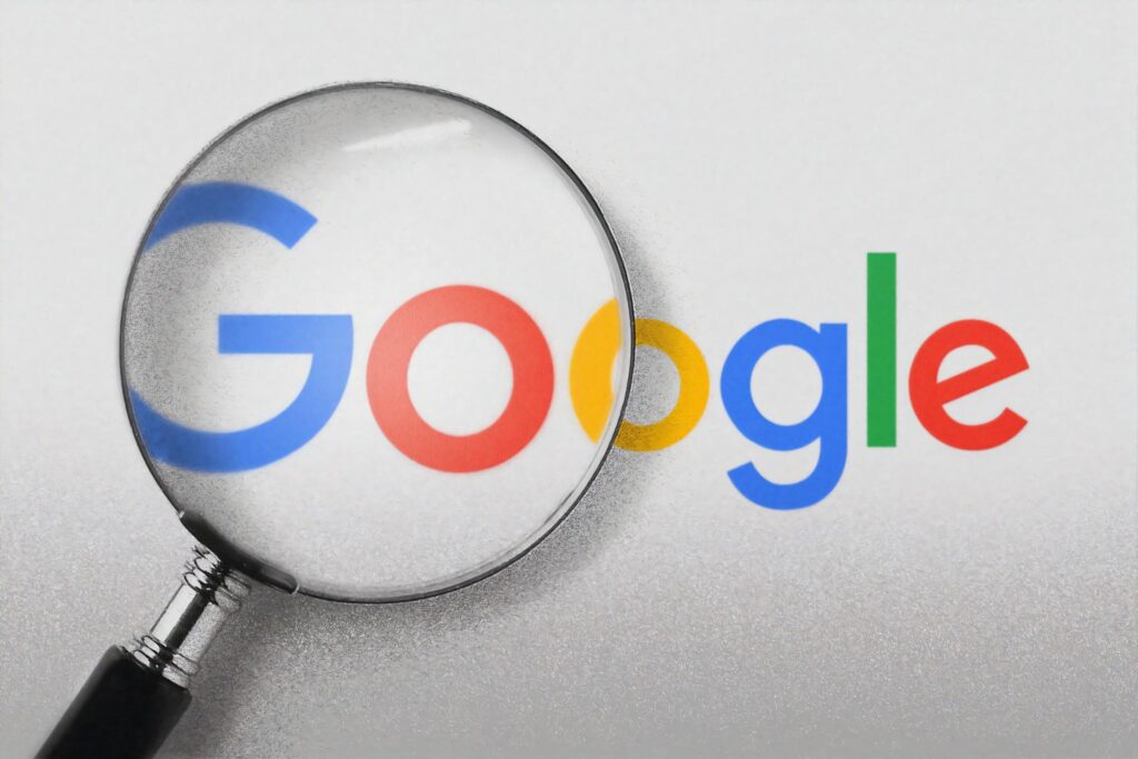 a magnifying glass enlarges the Google logo